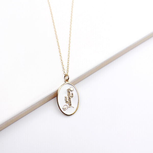 White enameled cactus necklace with a glossy finish on a delicate chain.