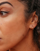 Elegant small featherweight gold hoops, perfect for a minimalist jewelry style