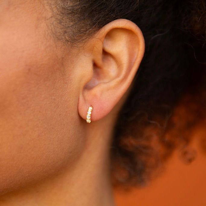 Classic huggie-style earrings featuring lustrous lab-created pearls.