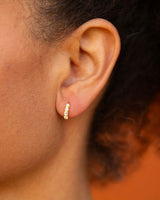 Classic huggie-style earrings featuring lustrous lab-created pearls.