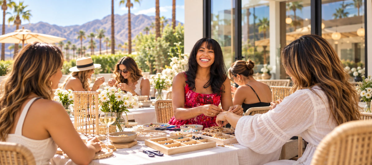 Guests making jewelry together around a table at an outdoor Covet event in Palm Springs